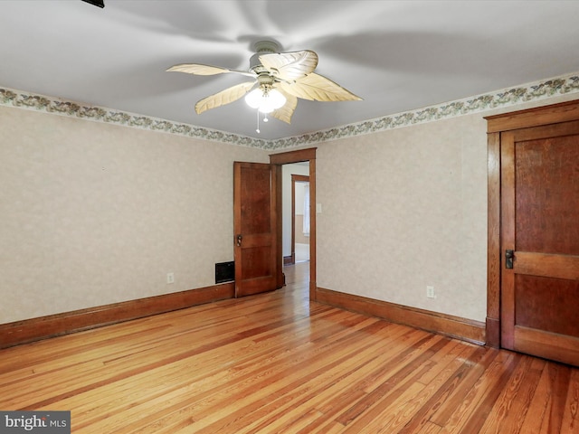 spare room with ceiling fan and light hardwood / wood-style floors