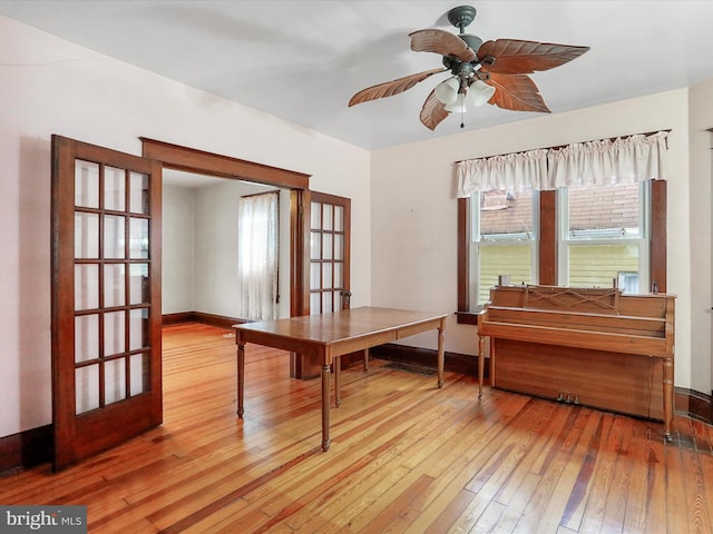 office with wood-type flooring, a healthy amount of sunlight, and ceiling fan