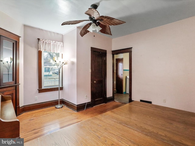 unfurnished bedroom featuring hardwood / wood-style flooring and ceiling fan