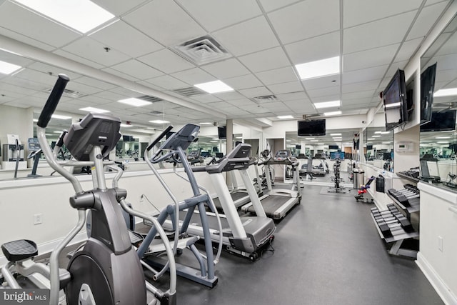 gym with a paneled ceiling