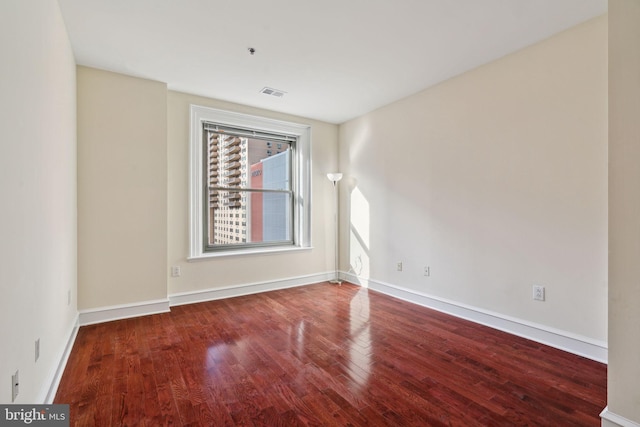 spare room with wood-type flooring