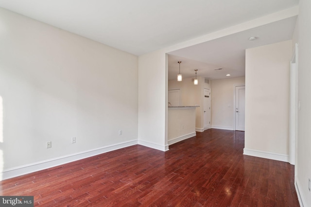 unfurnished living room featuring dark hardwood / wood-style floors