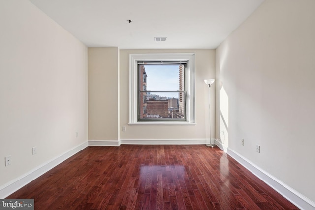 empty room with dark hardwood / wood-style floors