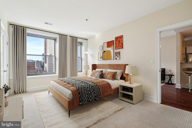 bedroom featuring light carpet