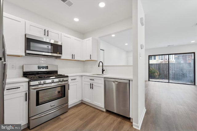 kitchen with white cabinetry, sink, and stainless steel appliances