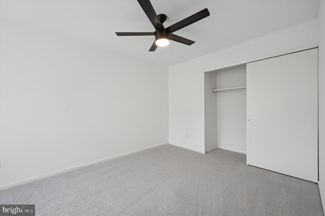 unfurnished bedroom featuring light colored carpet, a closet, and ceiling fan