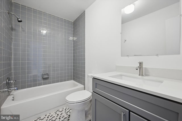 full bathroom with tiled shower / bath combo, vanity, and toilet