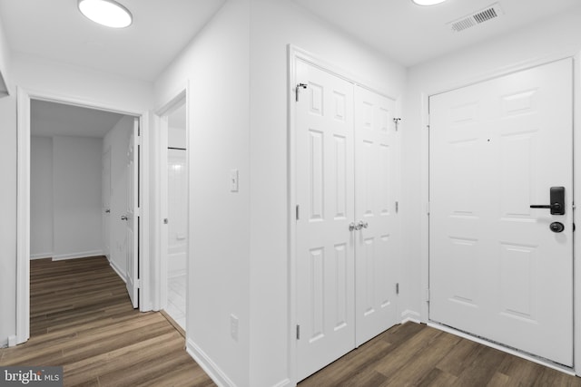 hallway with dark hardwood / wood-style floors