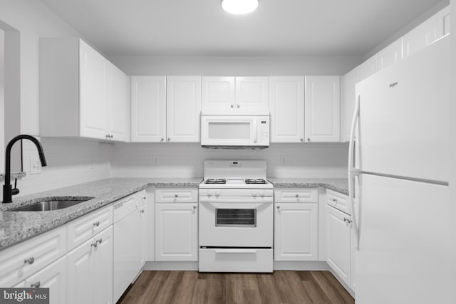 kitchen featuring white appliances, sink, and white cabinets