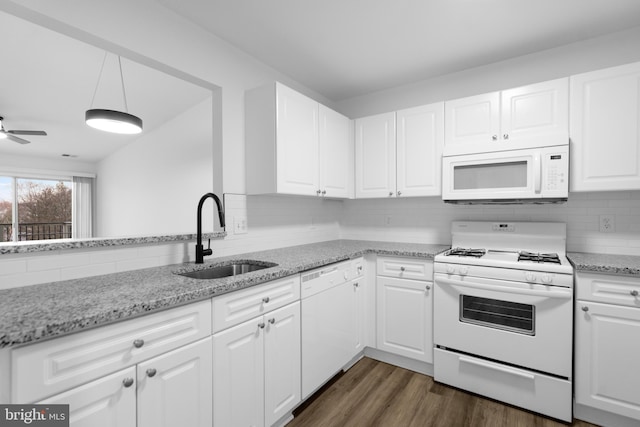 kitchen featuring white cabinetry, sink, light stone counters, and white appliances