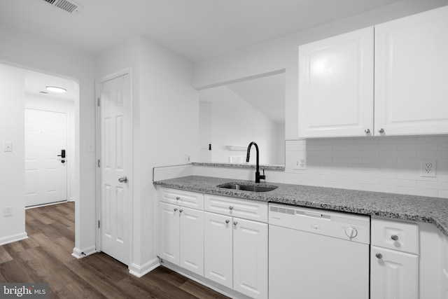 kitchen featuring white cabinetry, sink, backsplash, light stone counters, and white dishwasher