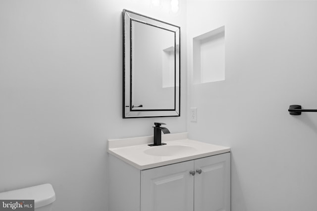 bathroom featuring vanity and toilet