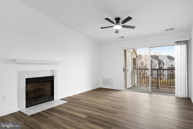 unfurnished living room featuring dark hardwood / wood-style flooring, a fireplace, and ceiling fan