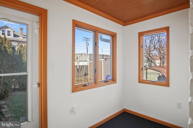 unfurnished room featuring crown molding and wooden ceiling