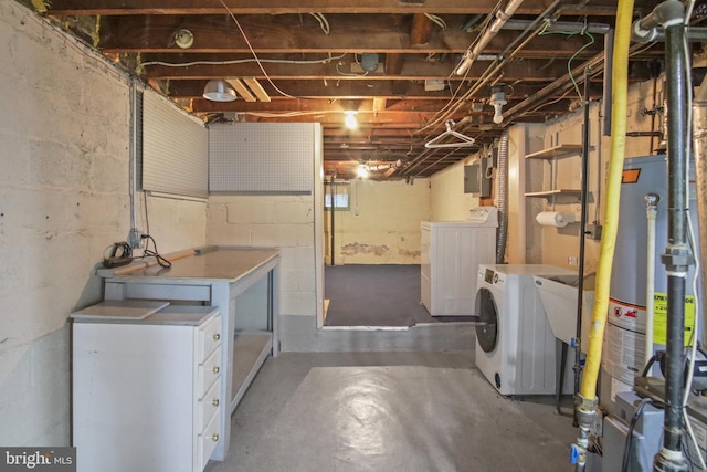 basement with sink, water heater, and washing machine and clothes dryer