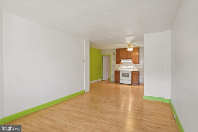 unfurnished living room with ceiling fan and light hardwood / wood-style flooring