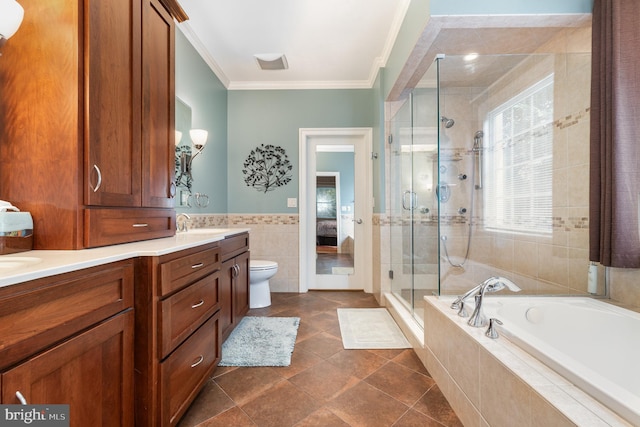 full bathroom featuring tile walls, vanity, separate shower and tub, toilet, and crown molding