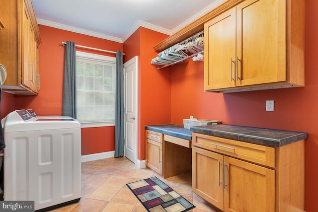 washroom featuring crown molding, cabinets, washer and clothes dryer, and light tile patterned floors