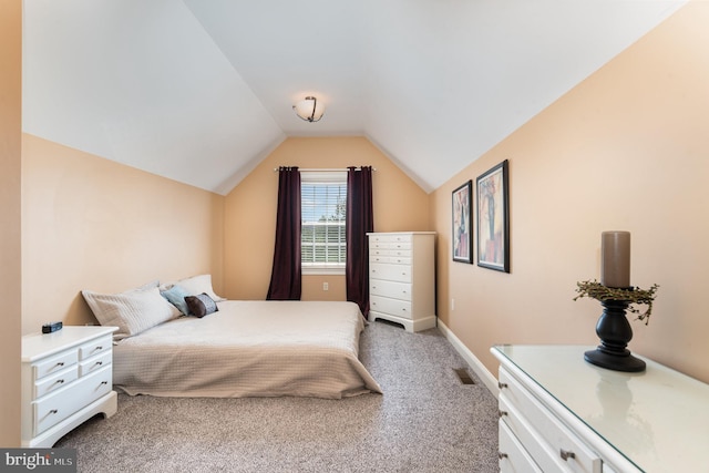 bedroom with carpet floors and vaulted ceiling