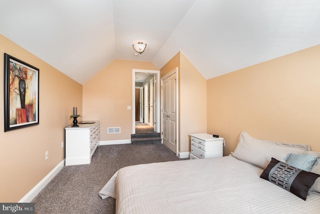 bedroom featuring dark carpet and vaulted ceiling