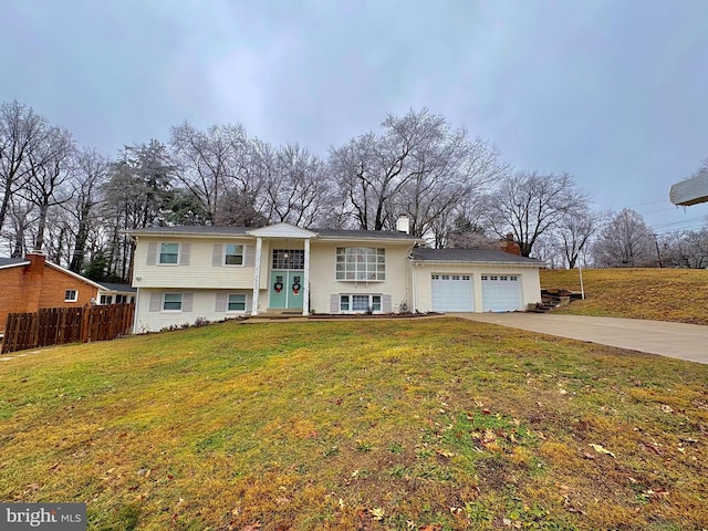 raised ranch with a garage and a front lawn