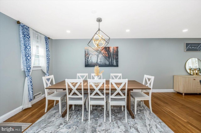 dining room with recessed lighting, wood finished floors, and baseboards