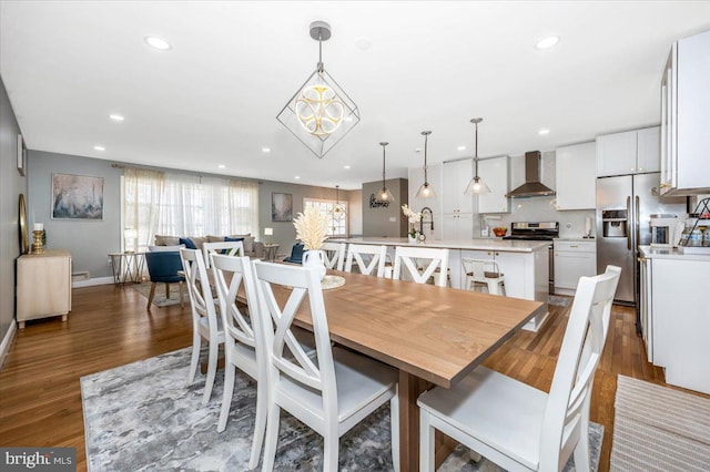 dining room with baseboards, a chandelier, dark wood-style flooring, and recessed lighting