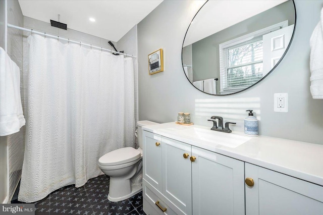 bathroom with curtained shower, vanity, and toilet