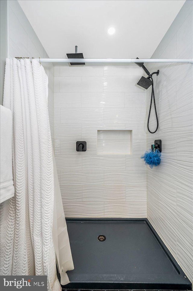 full bath with a tile shower