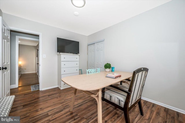 dining space featuring baseboards and dark wood-type flooring