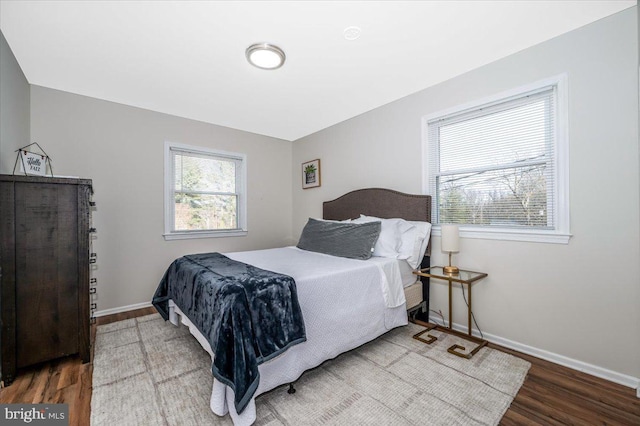 bedroom featuring baseboards and wood finished floors