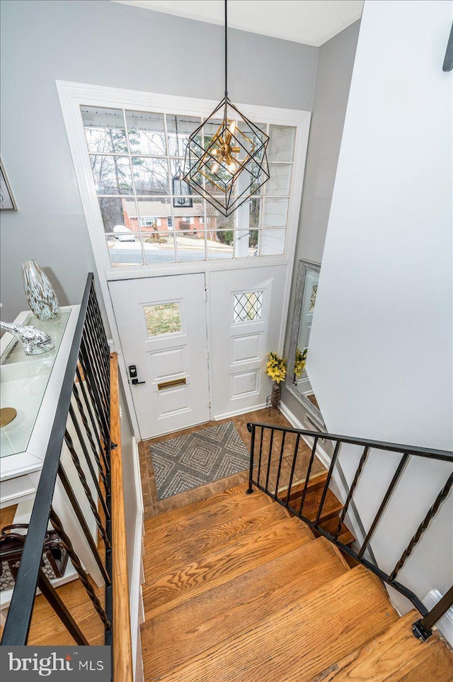 foyer entrance with stairs and a chandelier