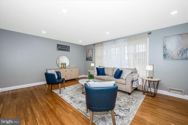 living area featuring baseboards and wood finished floors