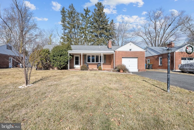 ranch-style home with a garage, a front lawn, and covered porch