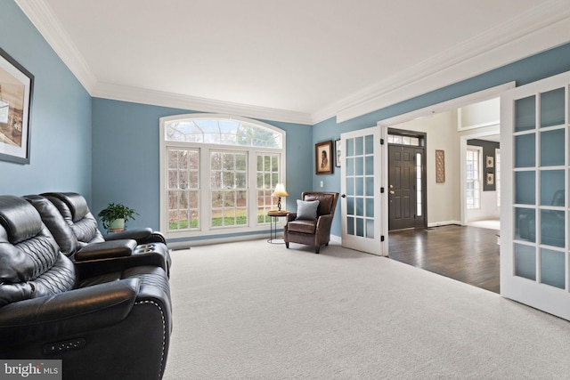 carpeted living room with crown molding and french doors