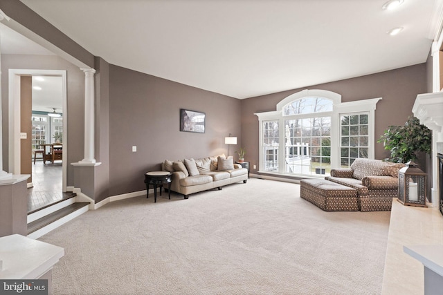 living room with decorative columns and carpet