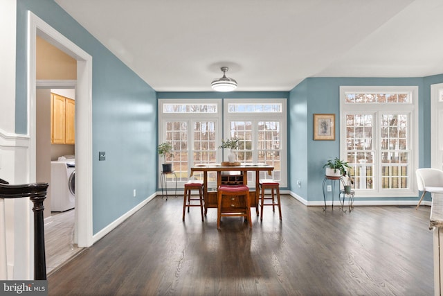 dining room with washer / dryer and dark wood-type flooring