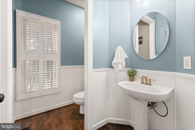 bathroom with toilet and hardwood / wood-style floors