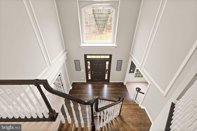 foyer entrance featuring a high ceiling and dark hardwood / wood-style floors