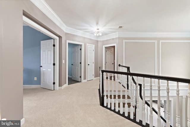 hall with crown molding and light colored carpet