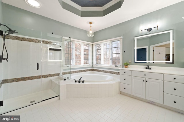 bathroom featuring tile patterned flooring, vanity, a tray ceiling, ornamental molding, and shower with separate bathtub