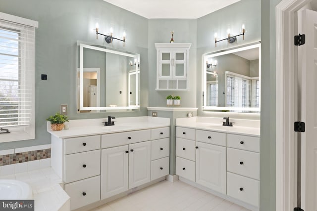 bathroom featuring vanity, a bathtub, and a wealth of natural light