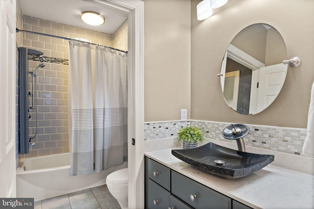 full bathroom featuring shower / bathtub combination with curtain, tile patterned flooring, vanity, decorative backsplash, and toilet