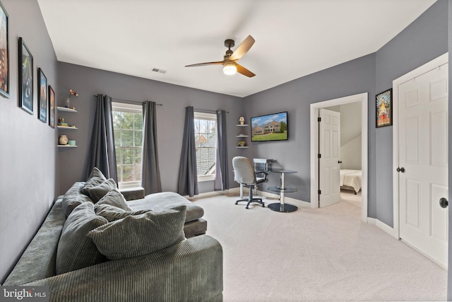 carpeted office featuring ceiling fan