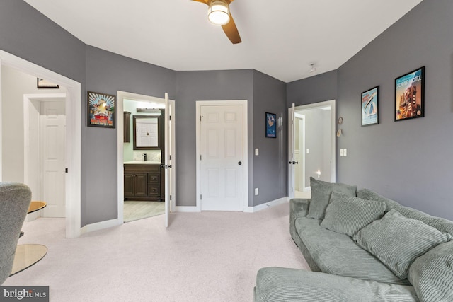 carpeted living room featuring ceiling fan