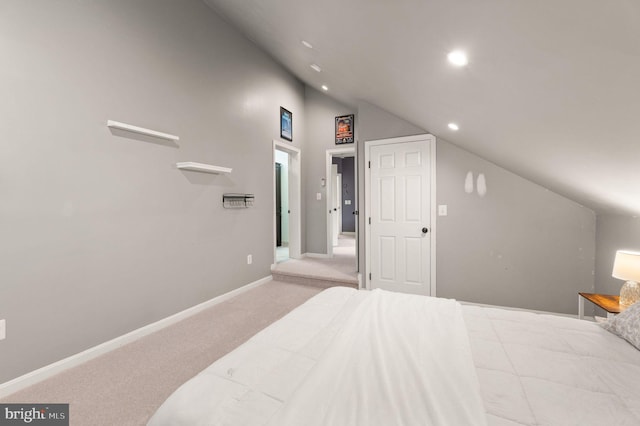 carpeted bedroom featuring lofted ceiling