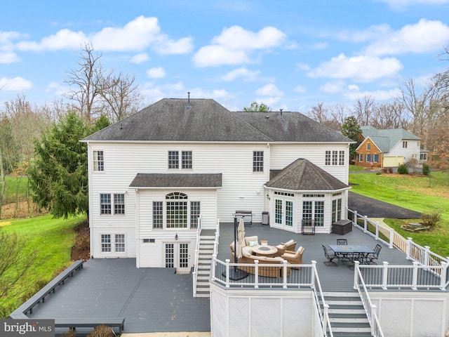 rear view of house with an outdoor living space, a wooden deck, and french doors