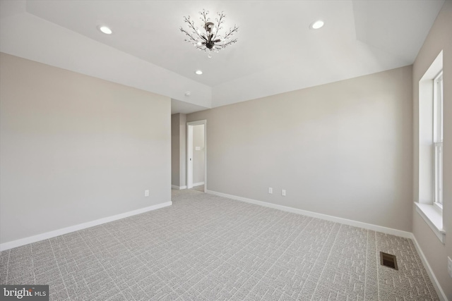 carpeted spare room featuring recessed lighting, visible vents, and baseboards