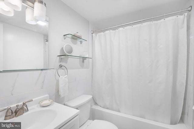 bathroom with decorative backsplash, vanity, toilet, and tile walls