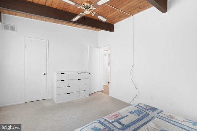 unfurnished bedroom featuring beamed ceiling, ceiling fan, light carpet, and wooden ceiling